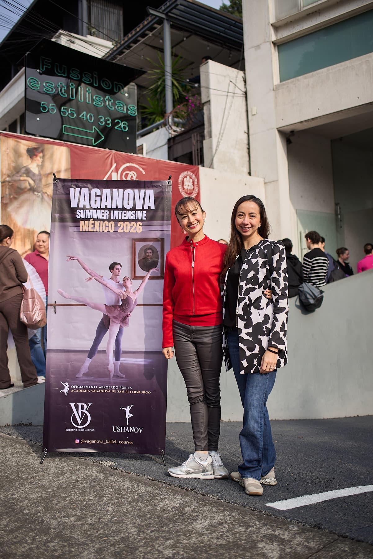 Smiles next to the official poster